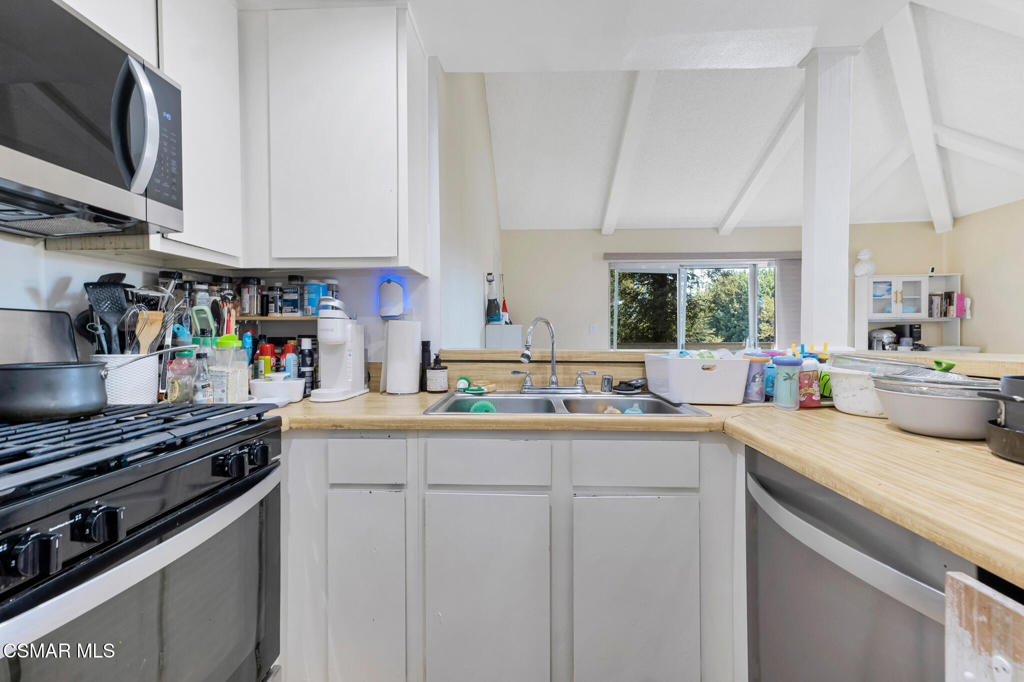 1932 Heywood Street, Unit B Simi Valley, CA 93065 - Photo 20 of 28 a kitchen with stainless steel appliances a sink stove and cabinets