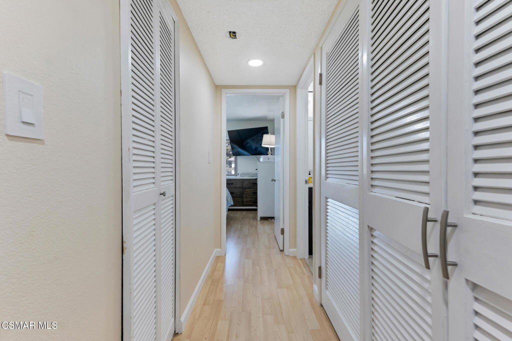 1932 Heywood Street, Unit B Simi Valley, CA 93065 - Photo 5 of 28 a view of a hallway with a dining table chair and a refrigerator
