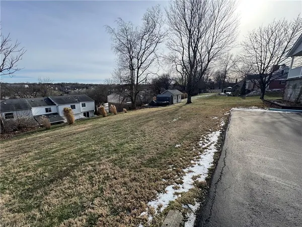 a view of a yard with cars