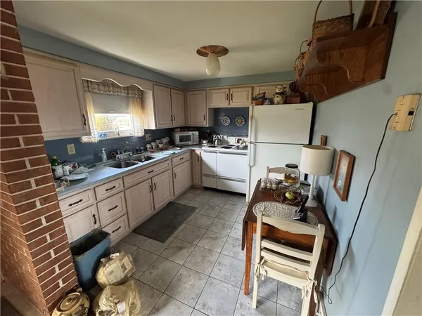 a kitchen with stainless steel appliances a stove a sink and a refrigerator