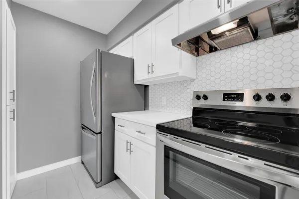 a kitchen with stainless steel appliances a refrigerator and a stove