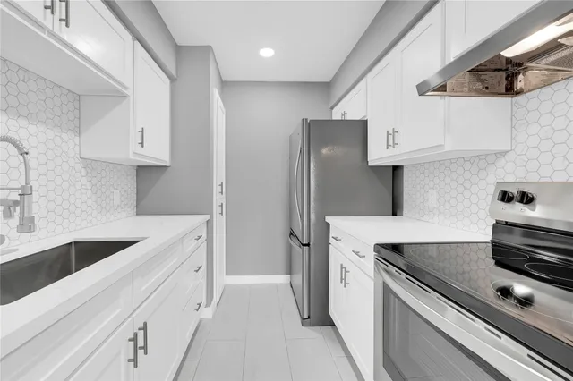 a kitchen with stainless steel appliances granite countertop a sink stove and refrigerator