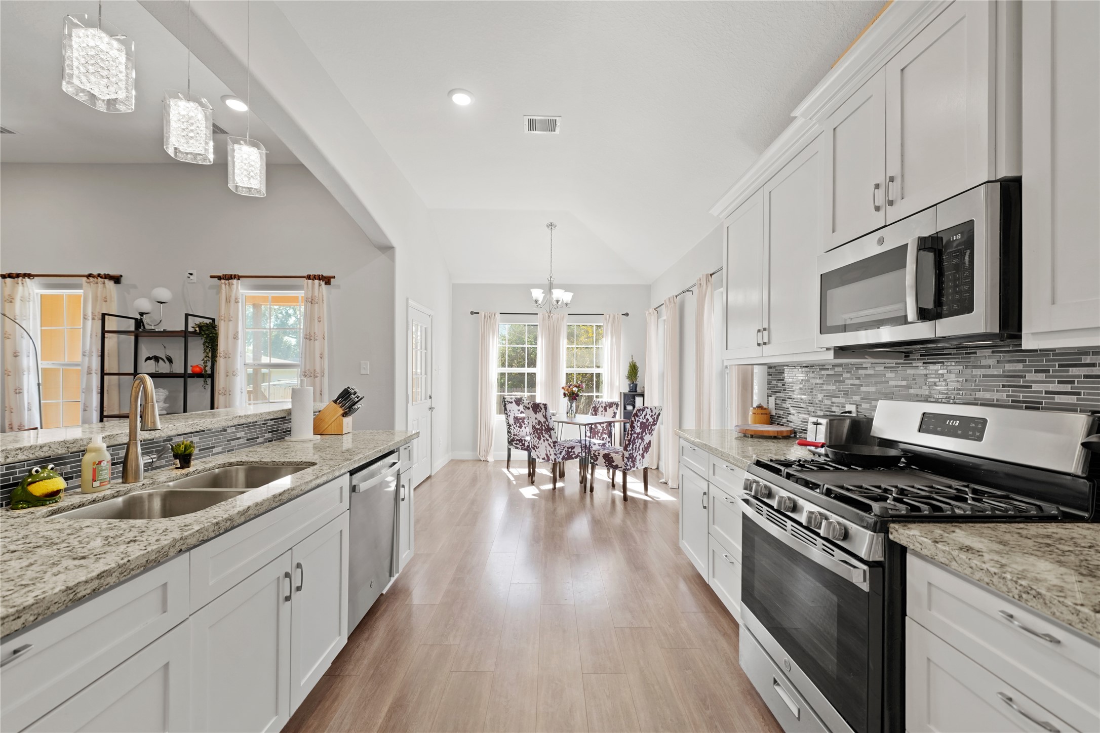 5602 Belmark Street Houston, TX 77033 - Photo 12 of 27 a large kitchen with stainless steel appliances granite countertop a lot of counter space and wooden floors