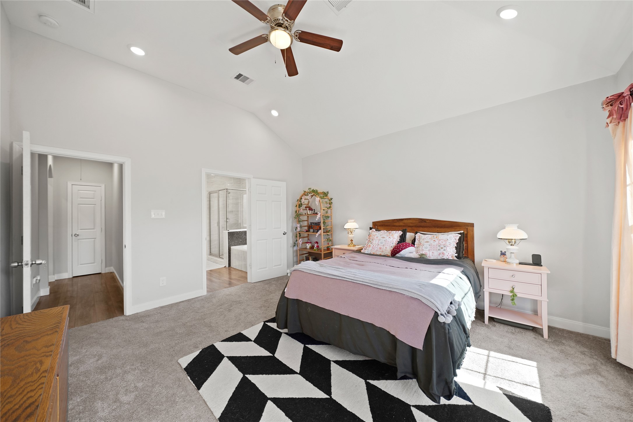 5602 Belmark Street Houston, TX 77033 - Photo 16 of 27 a bedroom with a bed and a chandelier