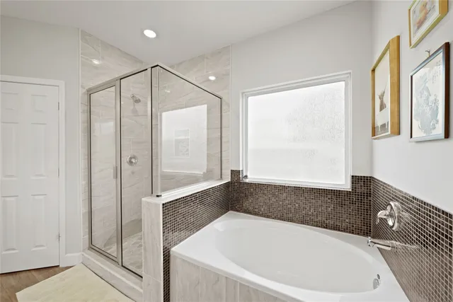 a bathroom with a bathtub and a shower