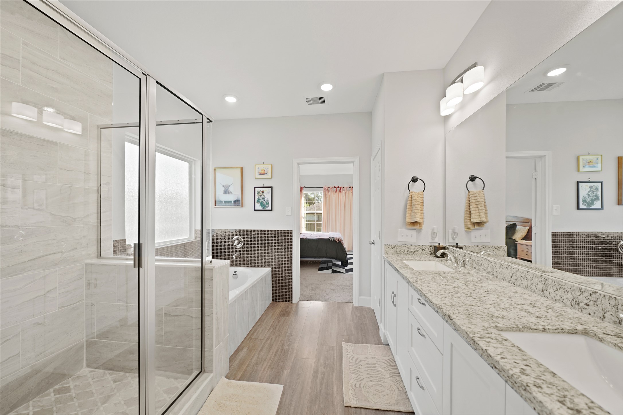 5602 Belmark Street Houston, TX 77033 - Photo 19 of 27 a large bathroom with a granite countertop sink a toilet a mirror and shower