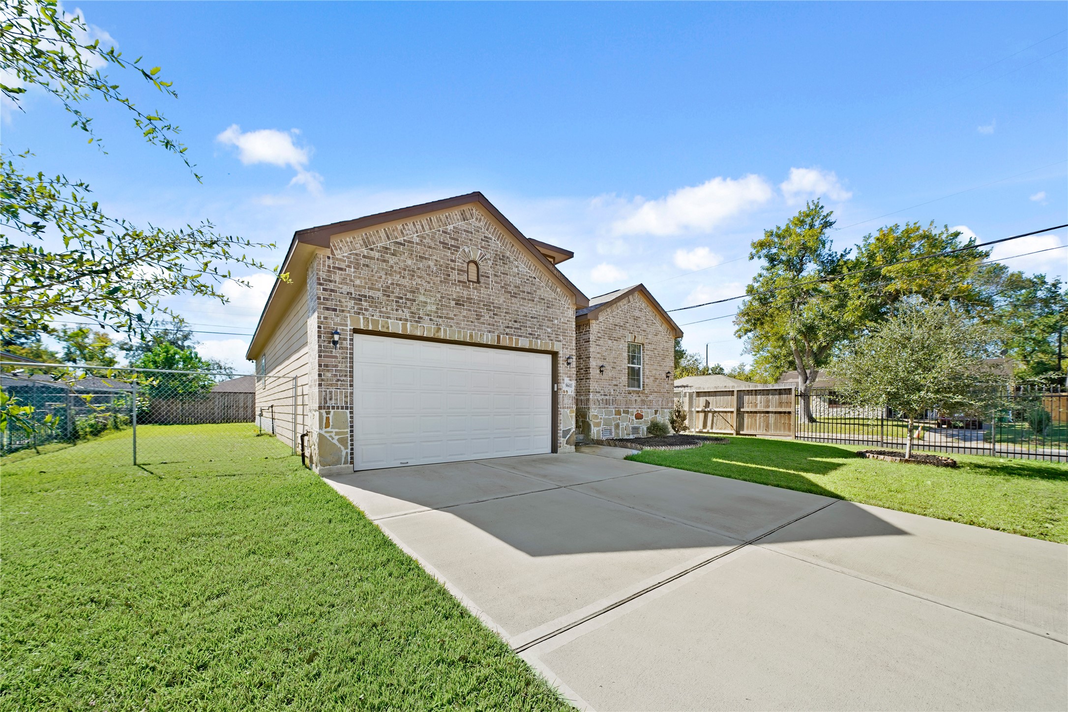 5602 Belmark Street Houston, TX 77033 - Photo 2 of 27 a front view of a house with a yard and garage