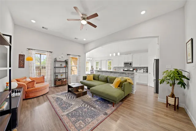 a living room with furniture and wooden floor
