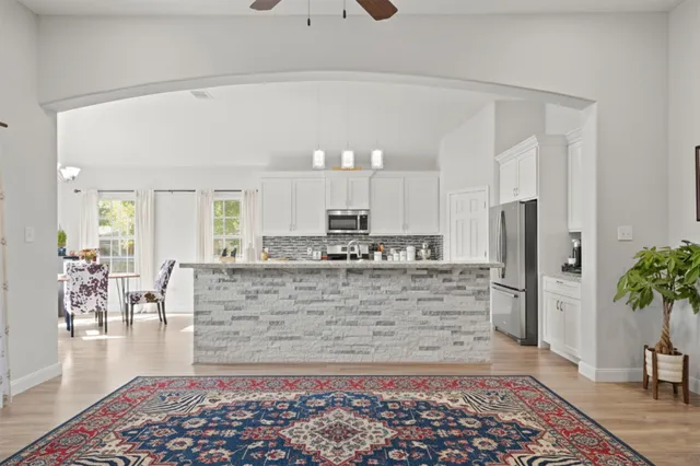 a view of living room with a couch and a rug
