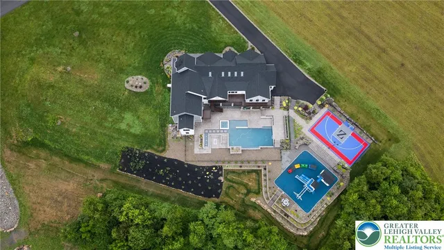 a view of a hallway with wooden floor and a kitchen space with a sink