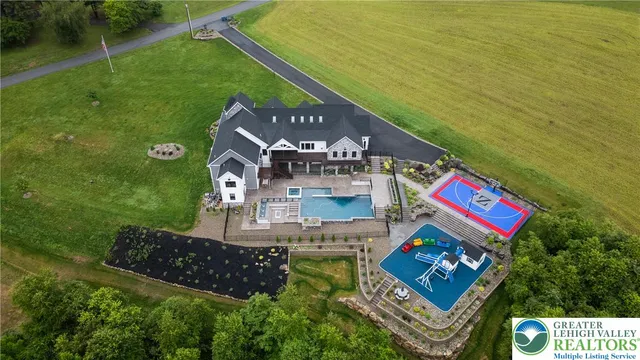 a view of an empty room with wooden floor and windows