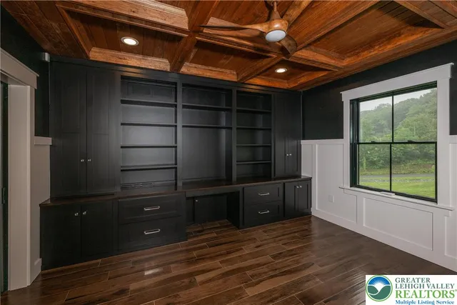 a large kitchen with kitchen island a counter space a sink stainless steel appliances and cabinets