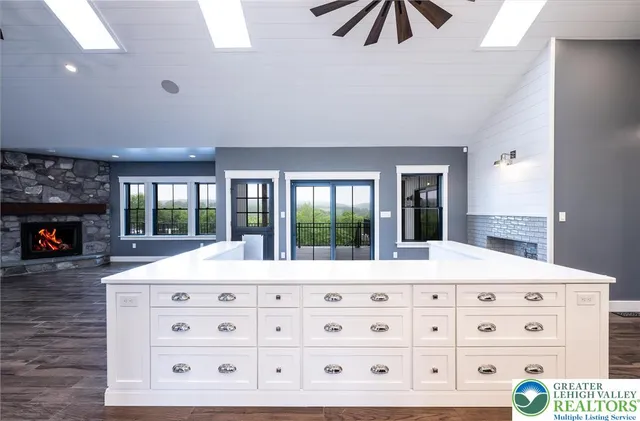 a bathroom with a sink a toilet a mirror and shower