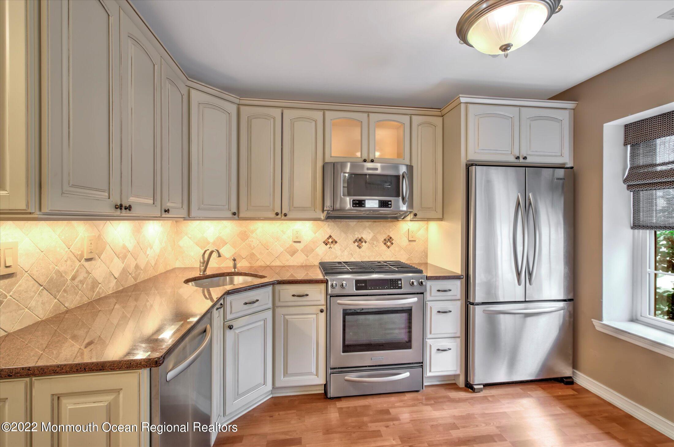 10 Hunters Oceanport, NJ 07757 - Photo 3 of 7 a kitchen with stainless steel appliances granite countertop a refrigerator sink and stove