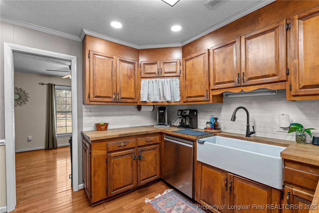 1284 Old Stage Road Fairmont, NC 28340 - Photo 17 of 48 a kitchen with stainless steel appliances granite countertop wooden cabinets a sink and dishwasher