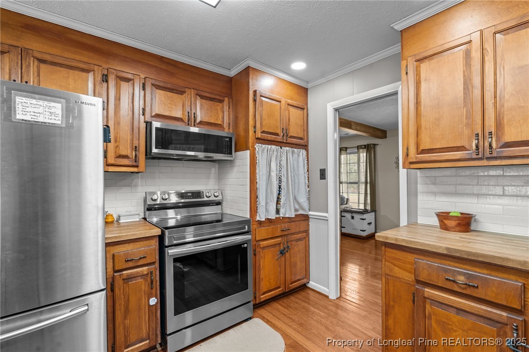 1284 Old Stage Road Fairmont, NC 28340 - Photo 18 of 48 a kitchen with stainless steel appliances granite countertop a stove a sink and a refrigerator