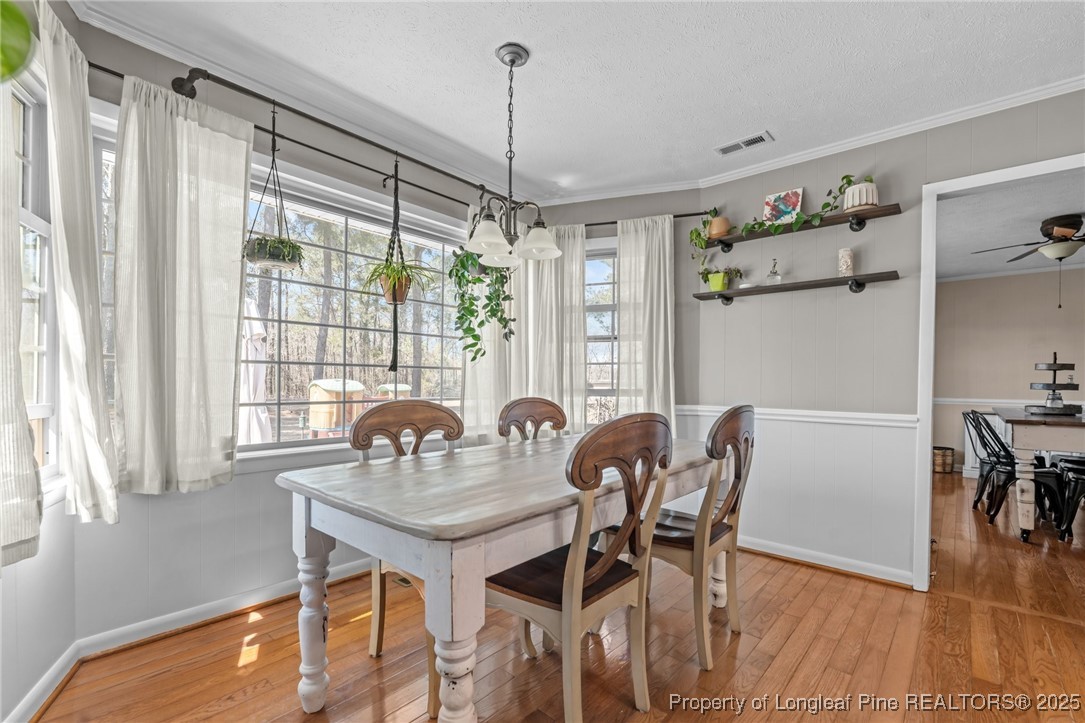 1284 Old Stage Road Fairmont, NC 28340 - Photo 23 of 48 a dining room with furniture a chandelier and wooden floor