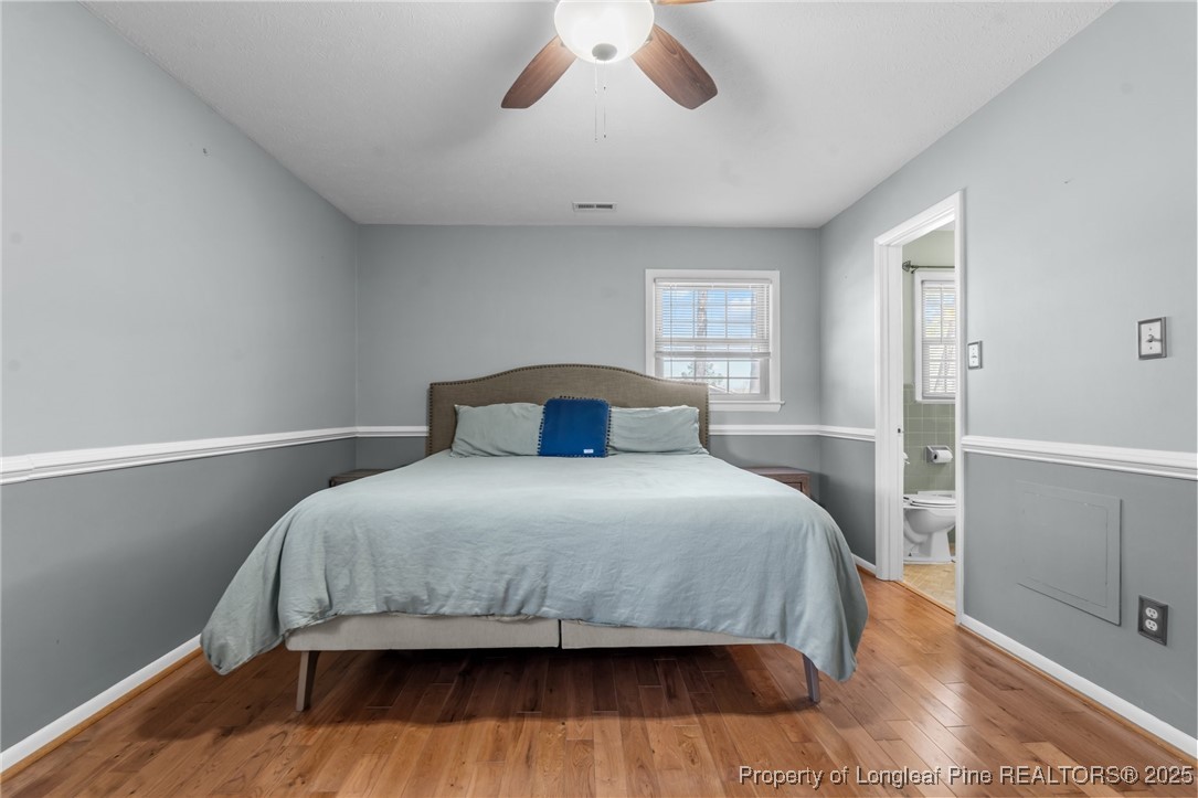 1284 Old Stage Road Fairmont, NC 28340 - Photo 26 of 48 a bedroom with a bed and wooden floor