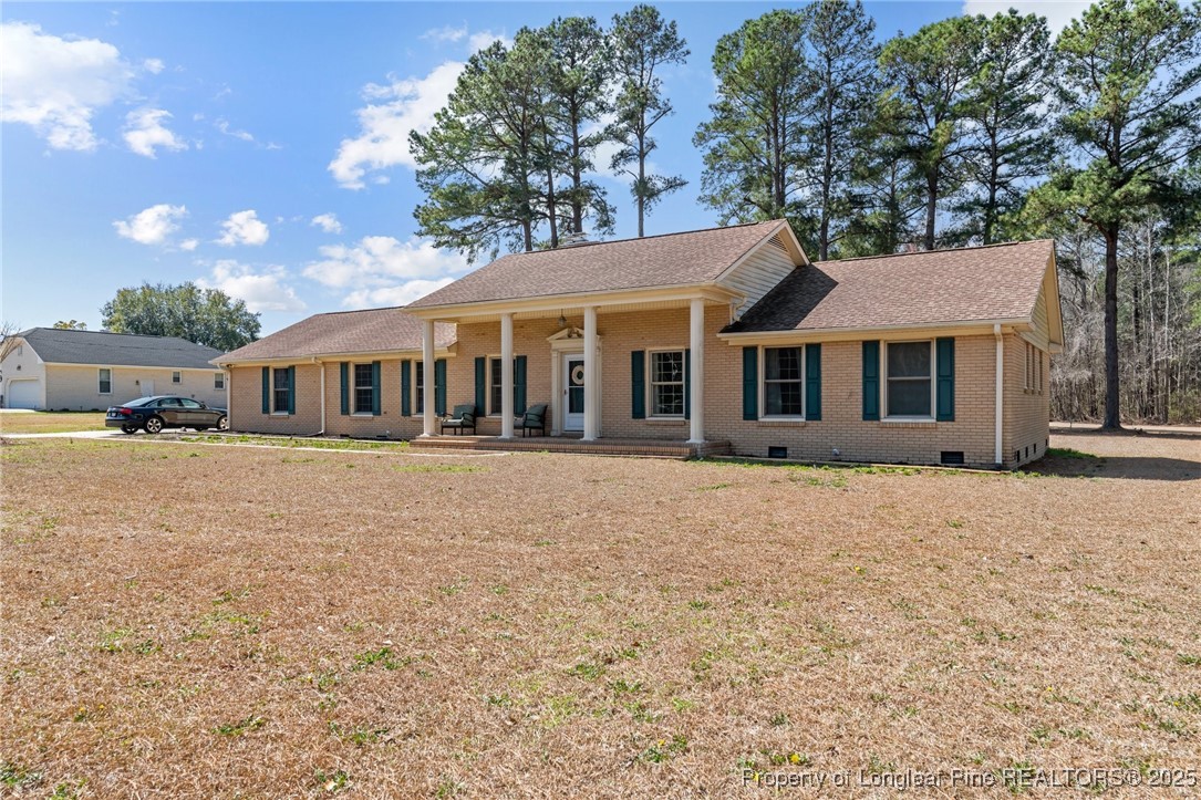 1284 Old Stage Road Fairmont, NC 28340 - Photo 3 of 48 a front view of a house with a garden