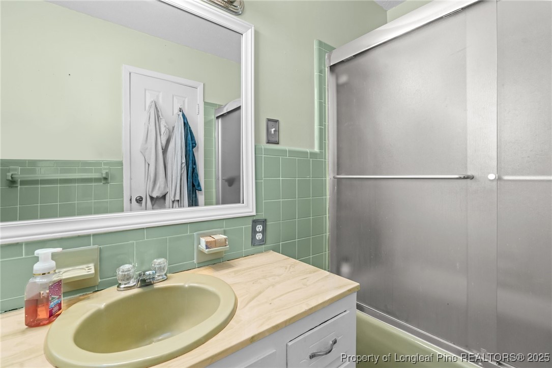 1284 Old Stage Road Fairmont, NC 28340 - Photo 33 of 48 a bathroom with a sink and a mirror