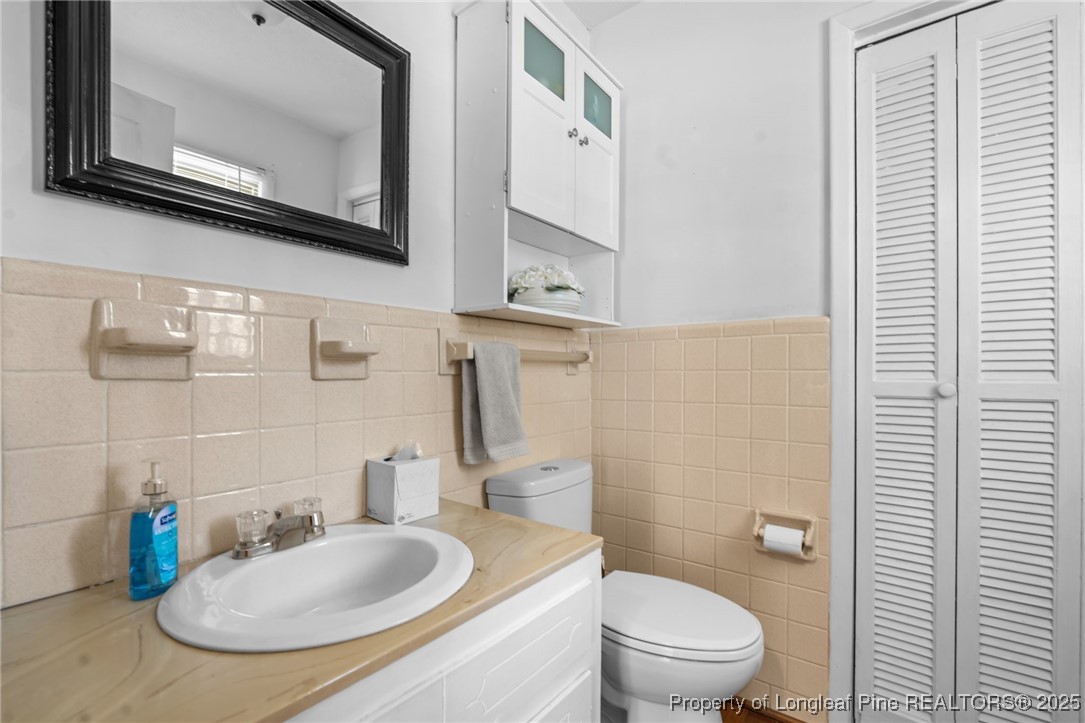 1284 Old Stage Road Fairmont, NC 28340 - Photo 36 of 48 a bathroom with a toilet a sink and mirror