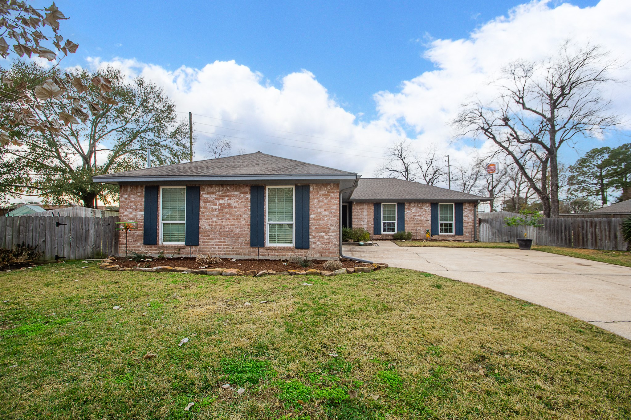 4830 Lost Oak Drive Spring, TX 77388 - Photo 2 of 41 Charming single-story brick home with a spacious driveway and attached garage. Features include a well-maintained front yard, mature trees, and a cozy, inviting exterior. Ideal for families seeking a suburban setting.