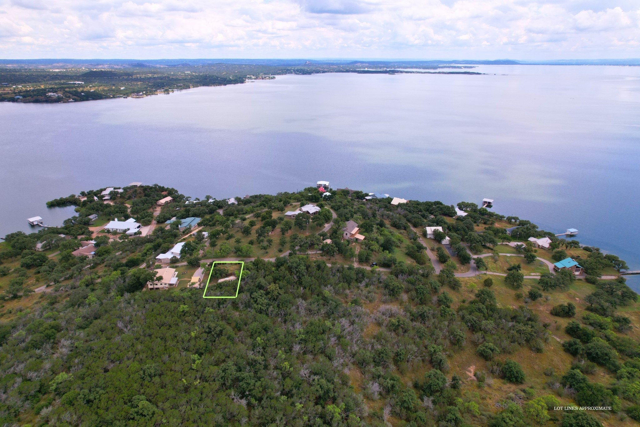 A verdant hillside property awaits, offering direct lake access and captivating water views.