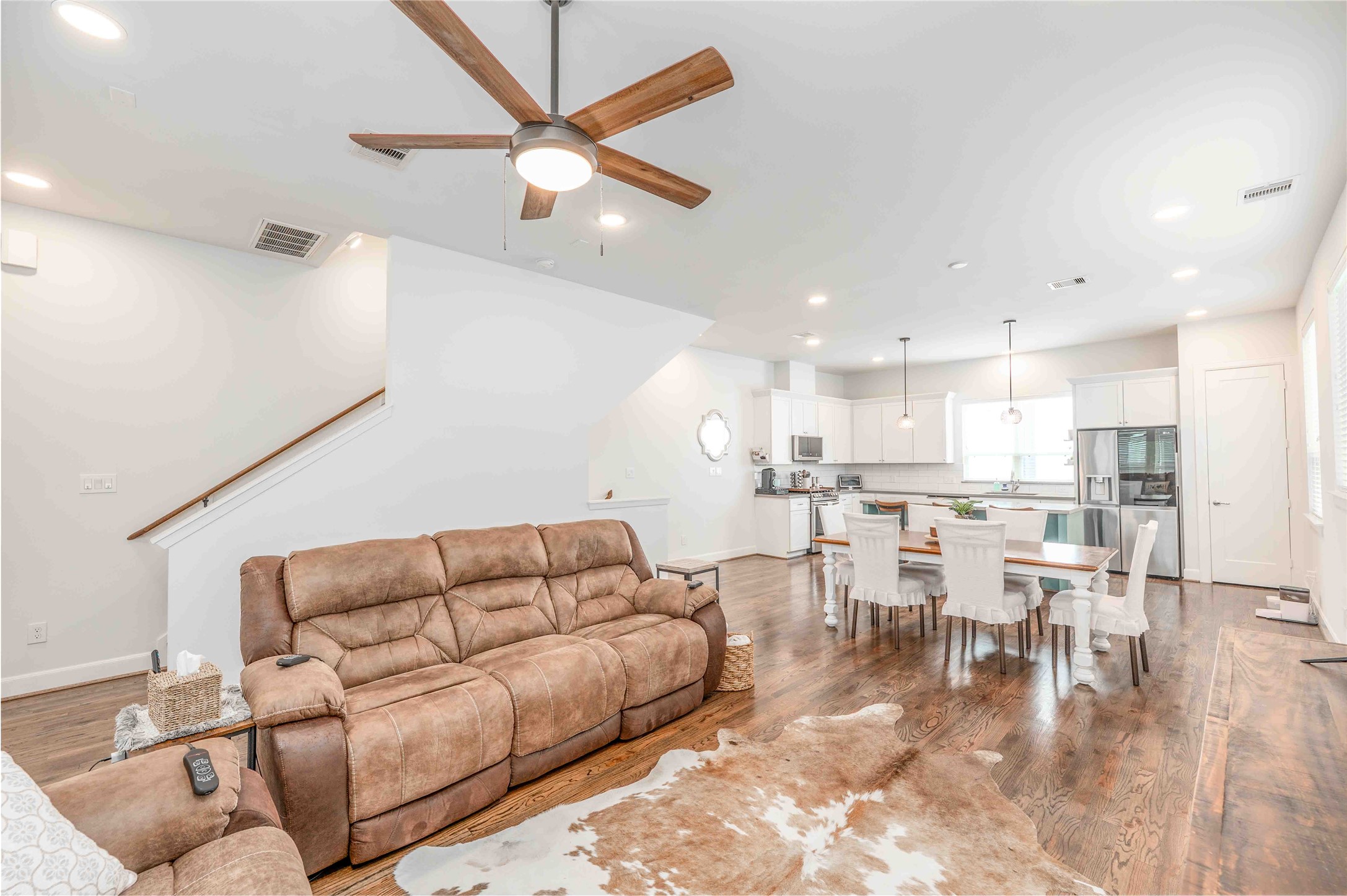 1038 Timbergrove Yards Lane Houston, TX 77008 - Photo 43 of 43 a living room with couches a dining table and kitchen view with wooden floor