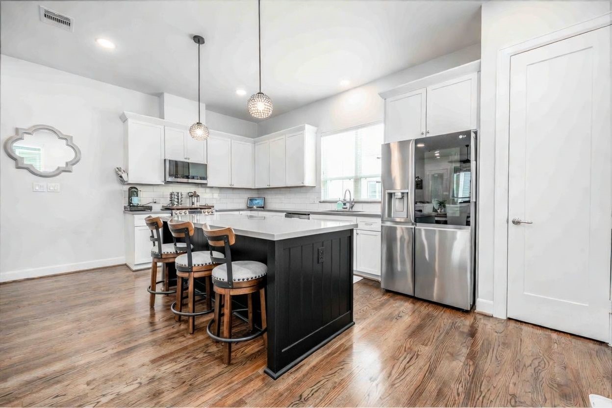 1038 Timbergrove Yards Lane Houston, TX 77008 - Photo 2 of 43 a kitchen with kitchen island granite countertop a sink a counter space stainless steel appliances and cabinets