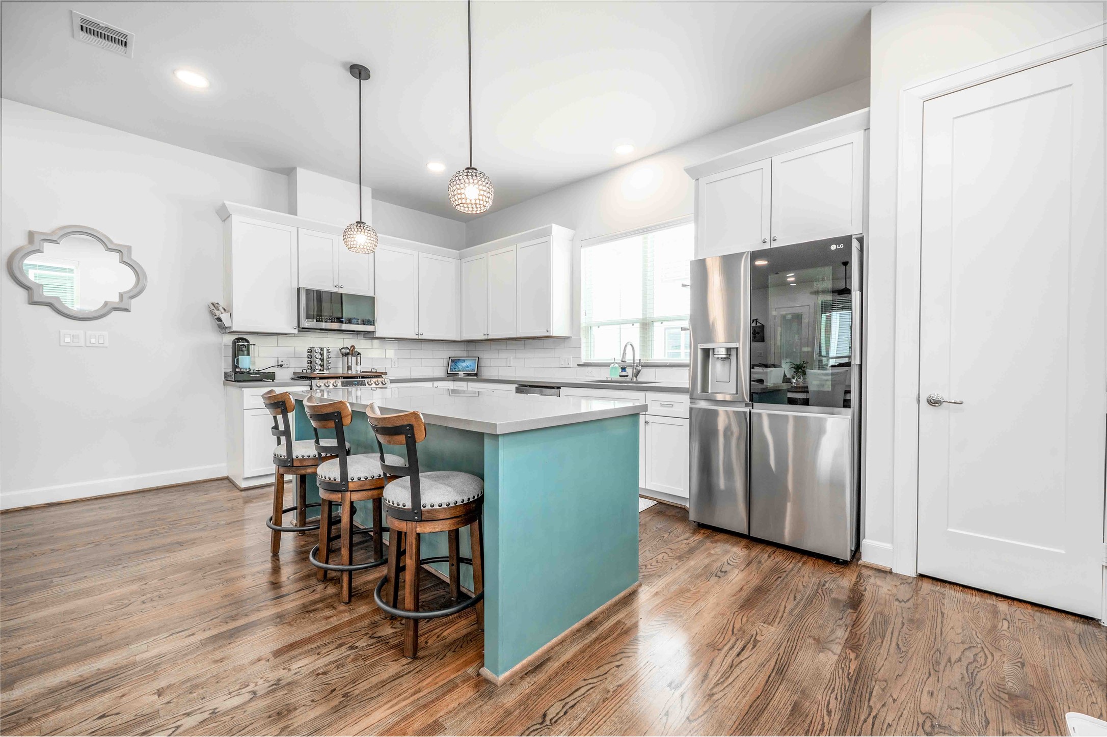 1038 Timbergrove Yards Lane Houston, TX 77008 - Photo 8 of 43 a kitchen with stainless steel appliances kitchen island a refrigerator a stove a sink and a dining table with wooden floor