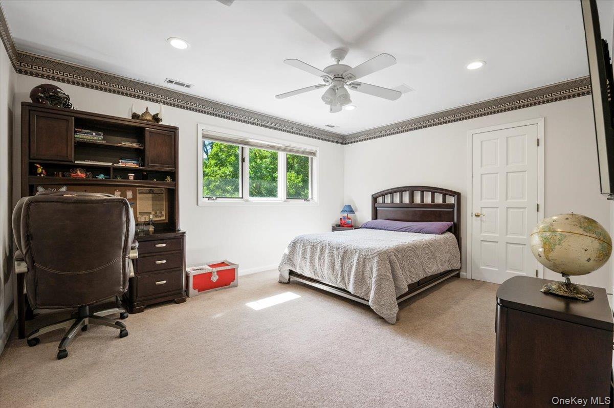 12 Ridge Court Glen Head, NY 11545 - Photo 34 of 46 Bedroom with light colored carpet, ornamental molding, ceiling fan, a desk, and recessed lighting