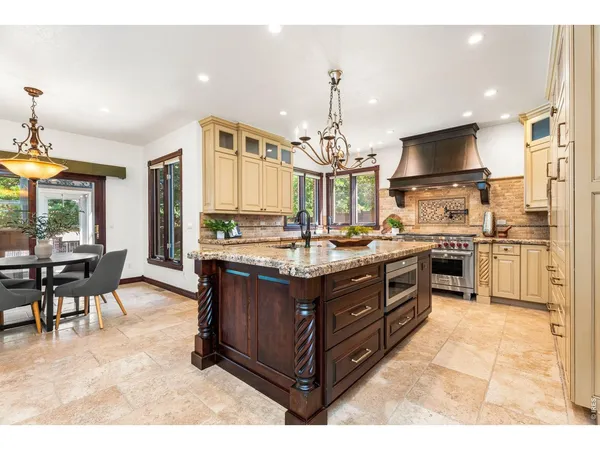 a kitchen with a sink stove and cabinets