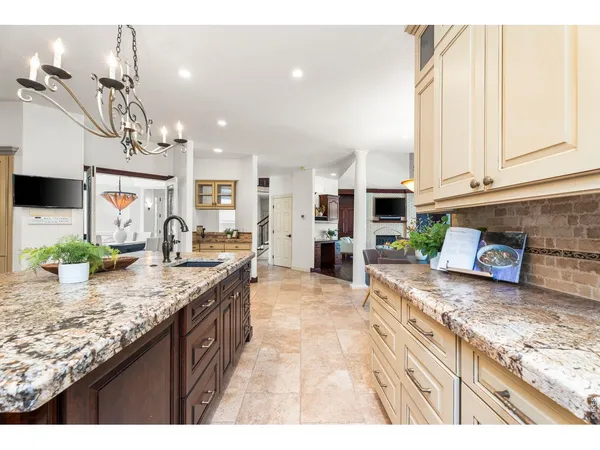 a kitchen with stainless steel appliances granite countertop a stove and a sink