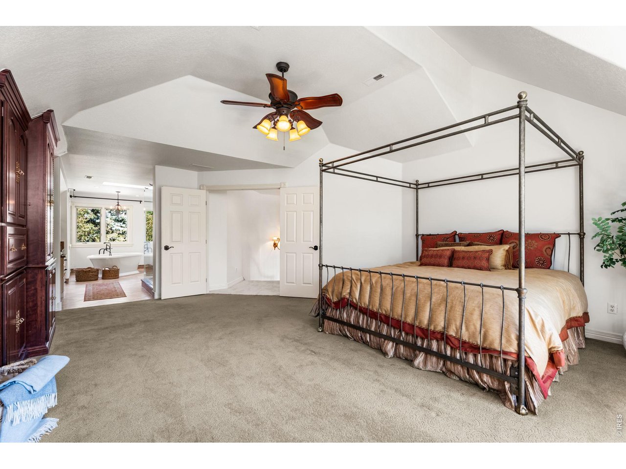 5100 Abbey Road Fort Collins, CO 80526 - Photo 26 of 49 a bedroom with a bed and a chandelier