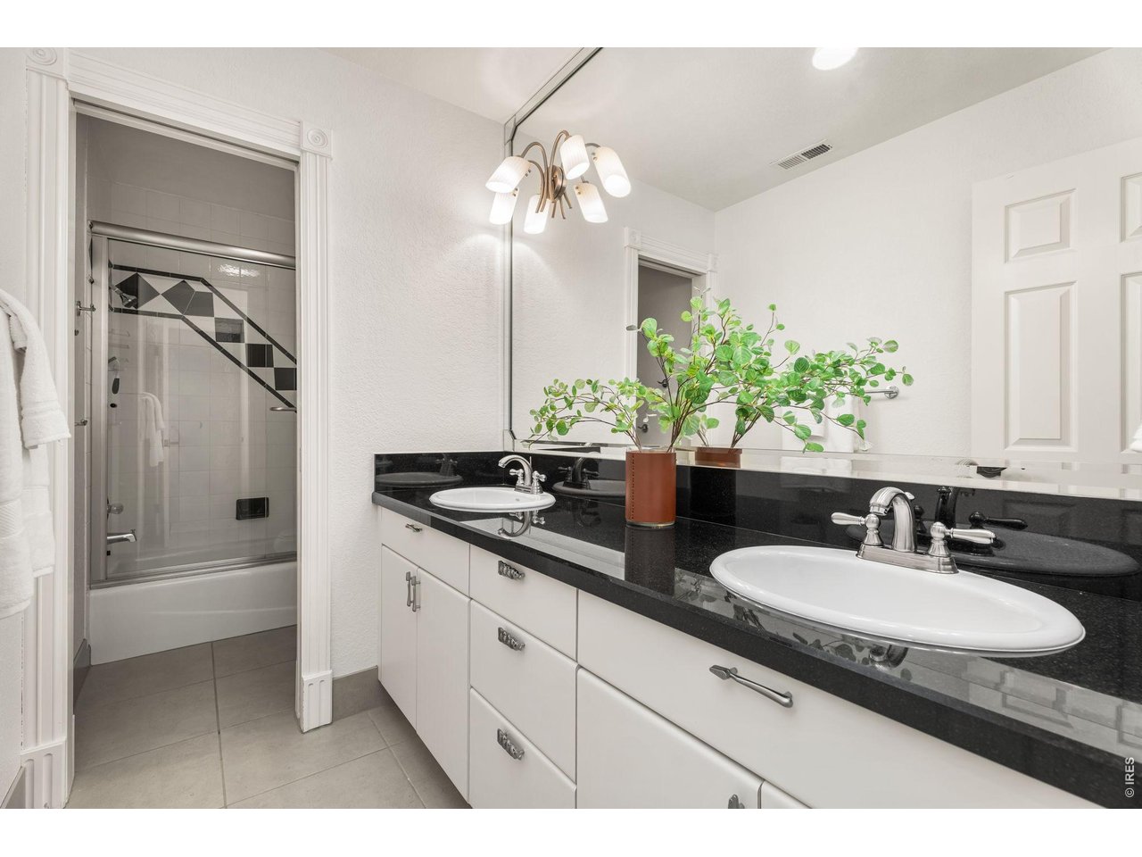 5100 Abbey Road Fort Collins, CO 80526 - Photo 32 of 49 a bathroom with a granite countertop sink a mirror and a shower