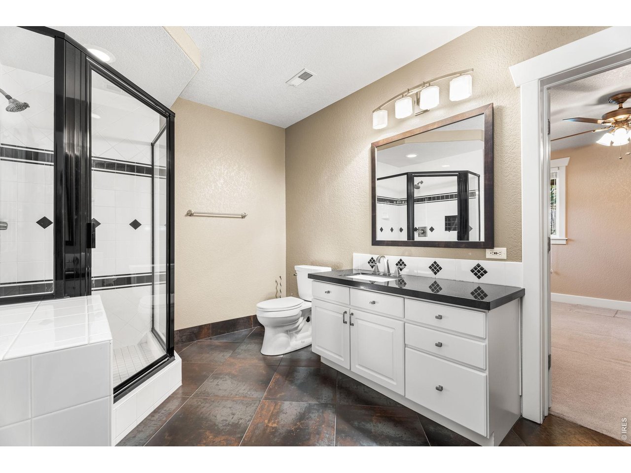 5100 Abbey Road Fort Collins, CO 80526 - Photo 42 of 49 a bathroom with a toilet a sink a mirror and a shower