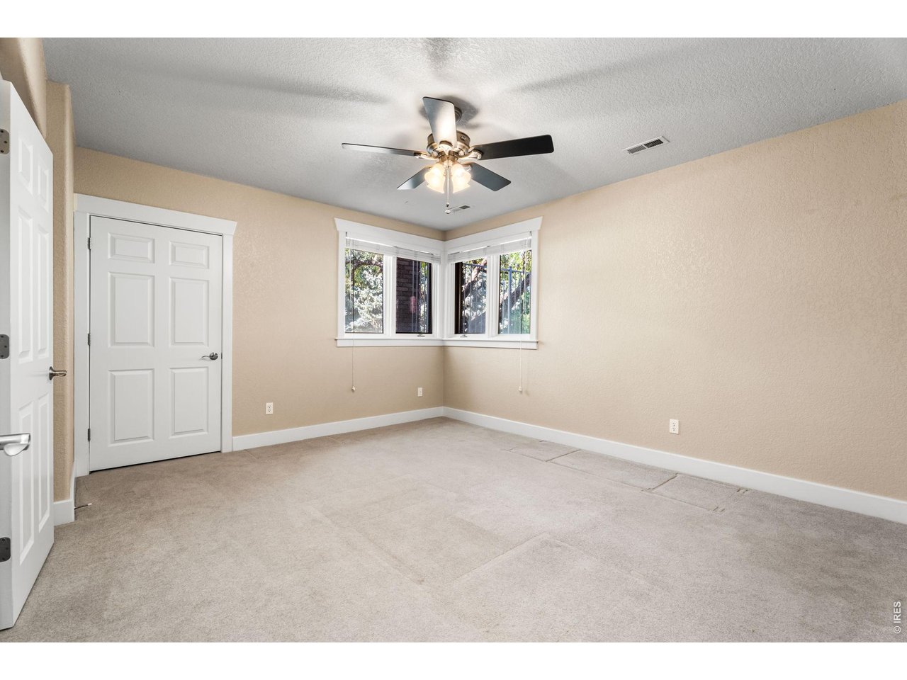5100 Abbey Road Fort Collins, CO 80526 - Photo 43 of 49 an empty room with chandelier fan and windows