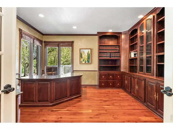 a view of dining room and livingroom with furniture wooden floor a chandelier