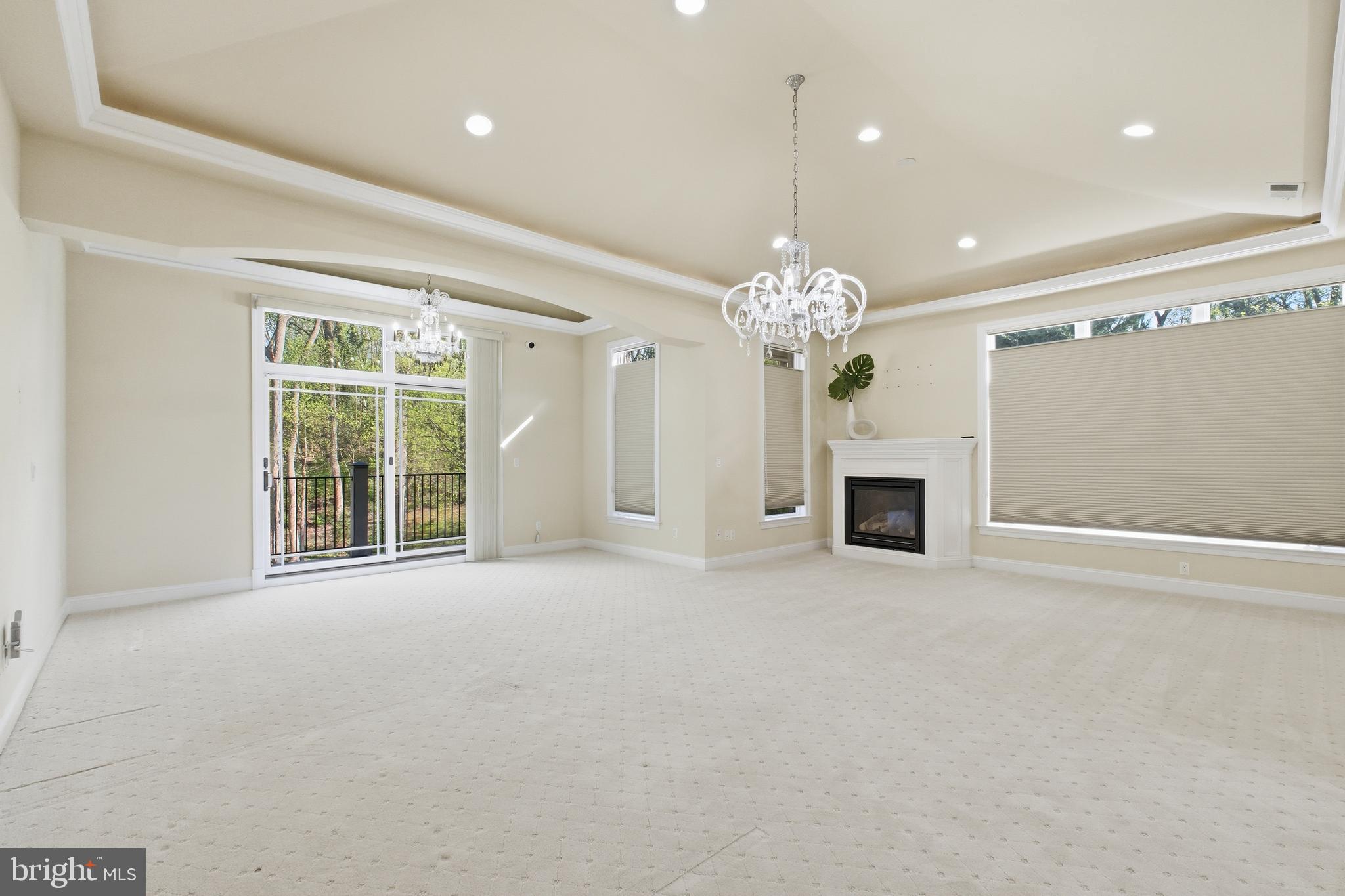 8735 Brook Road McLean, VA 22102 - Photo 14 of 20 a view of an empty room with a chandelier and fireplace