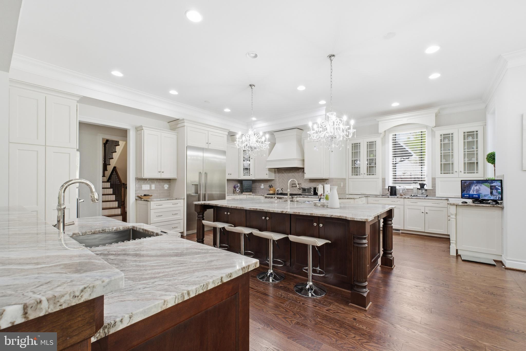 8735 Brook Road McLean, VA 22102 - Photo 9 of 20 a large kitchen with kitchen island a sink table and chairs