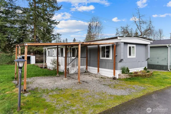 a view of a house with backyard and sitting area