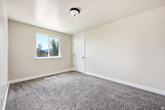 169 Taylor Road, Unit 101 Grantsville, UT 84029 - Photo 36 of 47 ADU - Room featuring plush gray carpeting and light neutral wall finishes