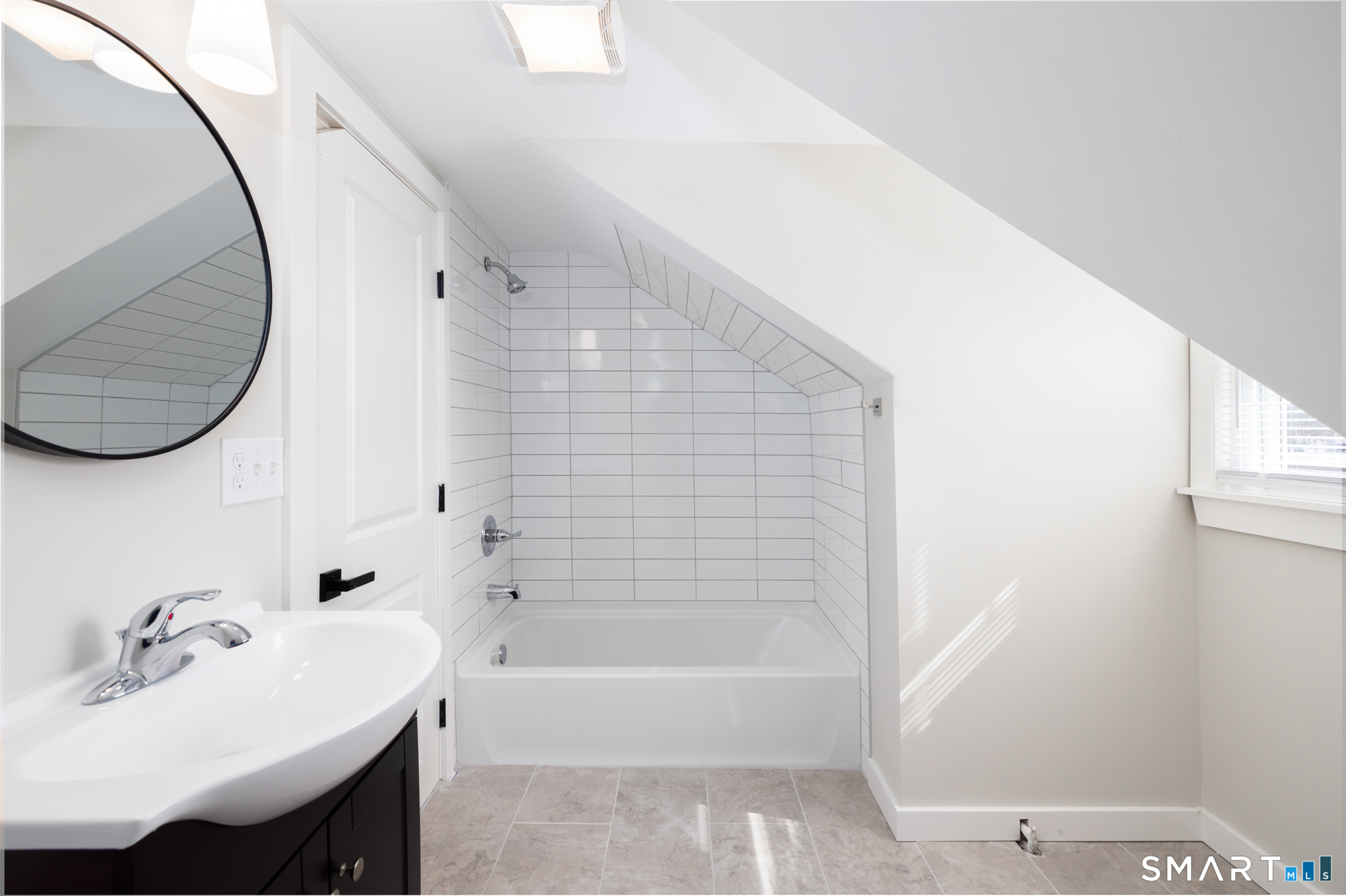 28 Aircraft Road, Unit J Southington, CT 06489 - Photo 11 of 18 a bathroom with a sink a bathtub and a mirror