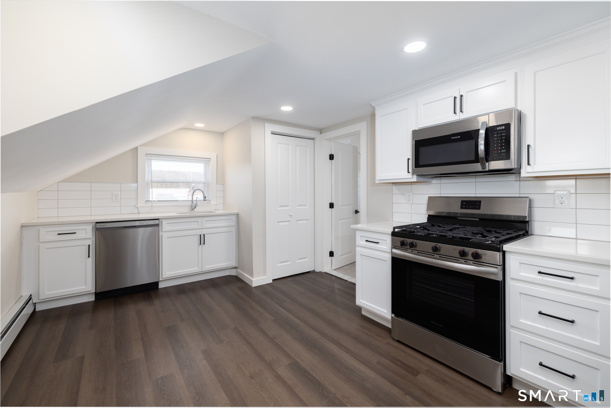 28 Aircraft Road, Unit J Southington, CT 06489 - Photo 3 of 18 a kitchen with stainless steel appliances a white stove top oven microwave and cabinets
