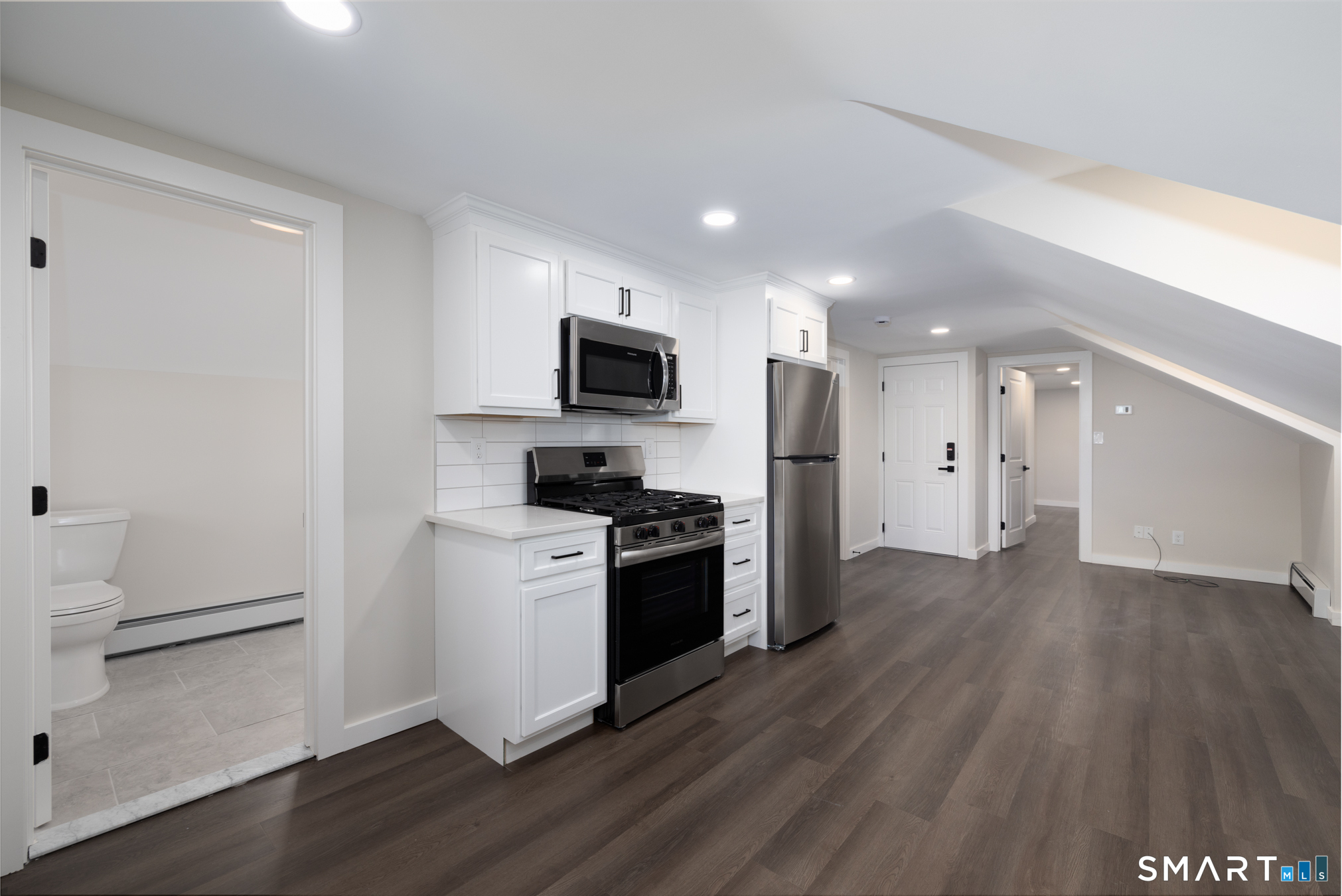 28 Aircraft Road, Unit J Southington, CT 06489 - Photo 4 of 18 a kitchen with a refrigerator and a stove top oven