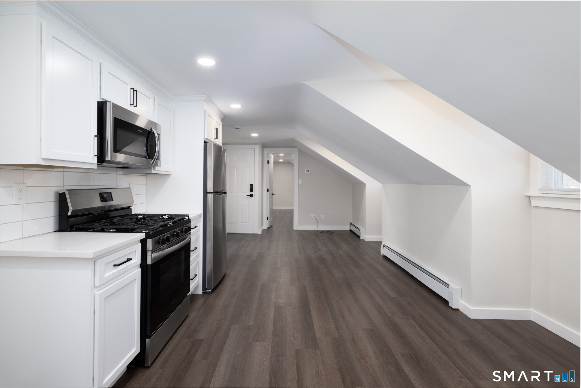 28 Aircraft Road, Unit J Southington, CT 06489 - Photo 5 of 18 a kitchen with stainless steel appliances a stove top oven a sink and a refrigerator