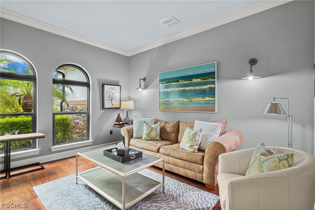 9383 Slate Court Naples, FL 34120 - Photo 12 of 28 a living room with furniture and floor to ceiling windows