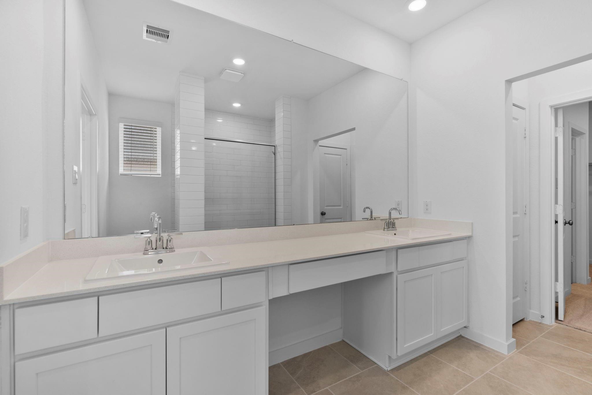 2716 Pine Bluff Drive Rosenberg, TX 77469 - Photo 16 of 32 a bathroom with double sink and a mirror