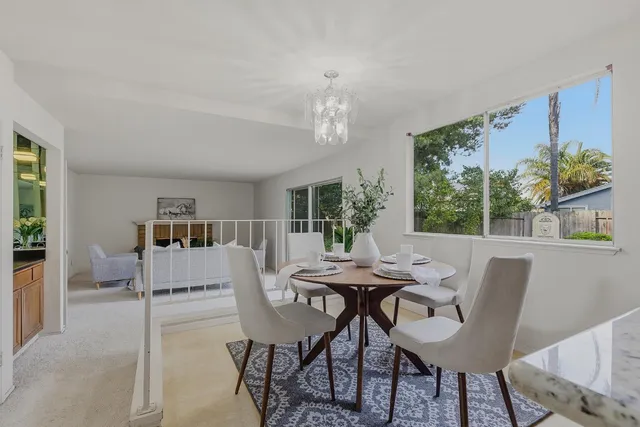 a view of a dining room with furniture window and outside view