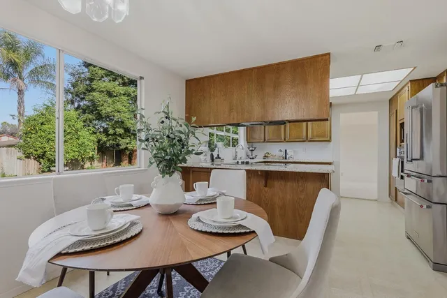 a view of a dining room with furniture and a large window